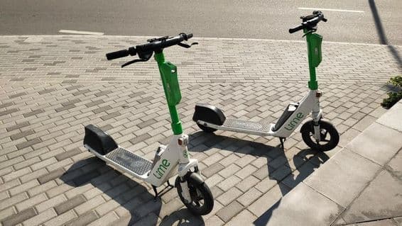 Lime kolobežky stojace na ulici v Dubaji.