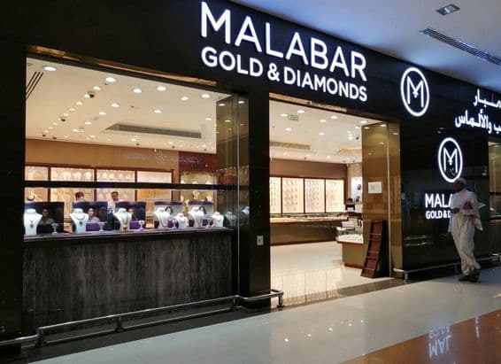 Emirátčan stojaci pred výlohami obchodu Malabar Gold & Diamonds.