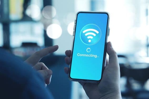 Muž používajúci smartphone na pripojenie k Wi-Fi.