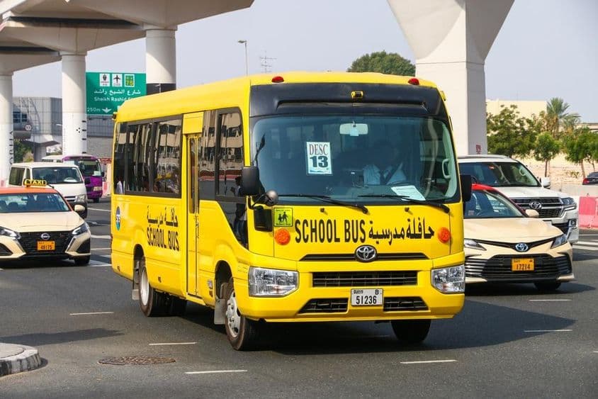 Školský autobus Toyota Coaster na mestkej ulici.