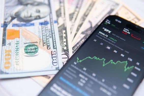 Index S&P 500 na obrazovke smartfónu, s pozadím doláru USA.