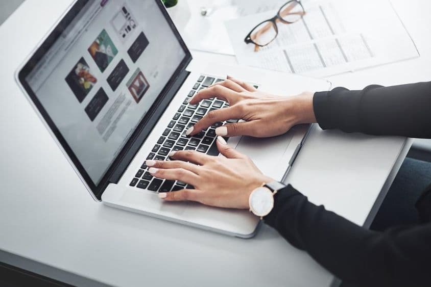 Žena pracujúca na diaľku z domu pomocou laptopu.