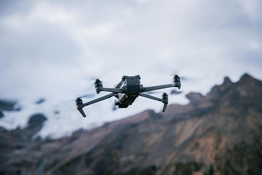 Dron letí nad vysokohorským vrcholom.