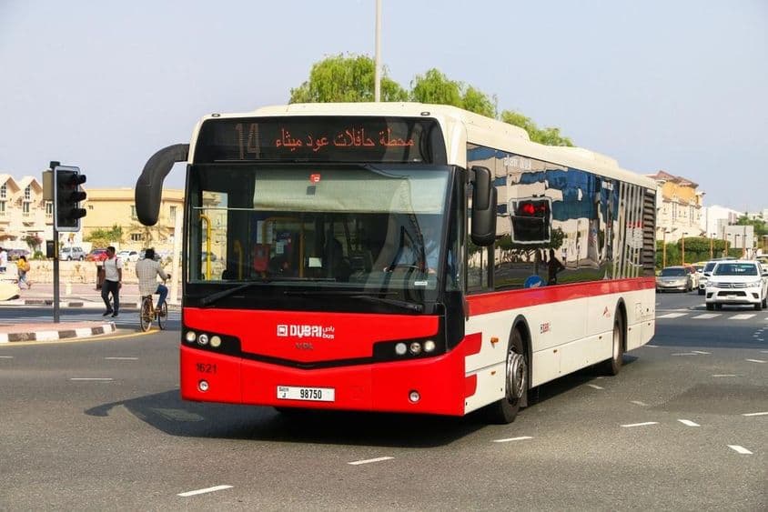 Červený mestský autobus v Dubaji na ulici.