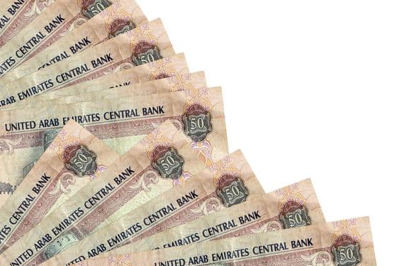 50-dirrhamová bankovka Spojených arabských emirátov ležiaca na stole.