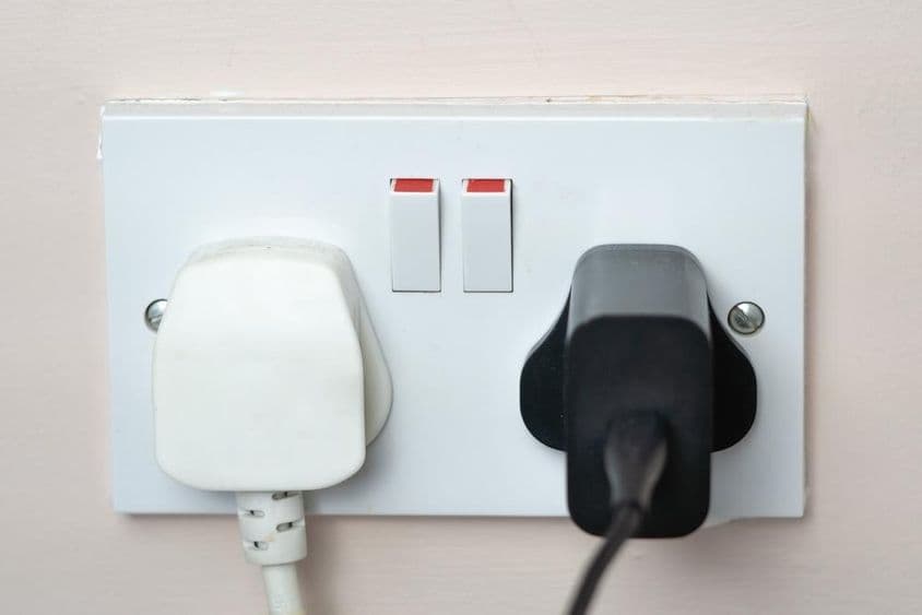 Anglická zásuvka v stene s vypínačmi.