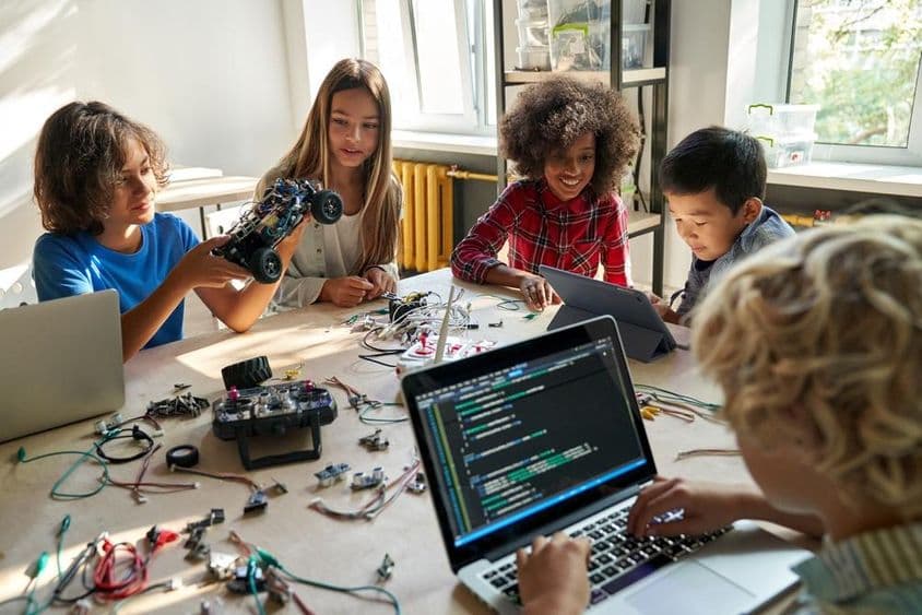 Školáci stavajú robotické autíčka pomocou počítačov a programovania.