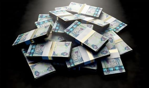 Kopa dirhamových bankoviek roztrúsená náhodne.