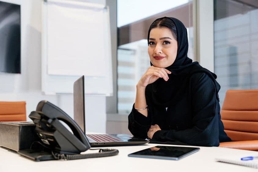 Biznis žena na Blízkom východe nosiaca tradičnú arabskú abaju v kancelárii.