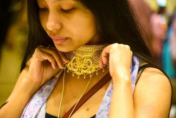 Žena skúša šperky na Dhanteras.
