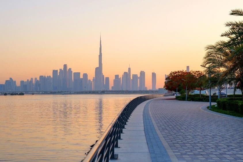 Krásne nábrežie s kvitnúcimi stromami, pohľad na centrum Dubaja.