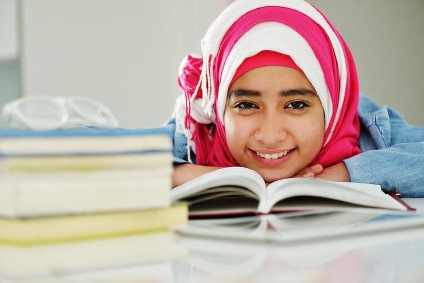 Krásna arabská muslimská dievčina čítajúca na vysokej škole.