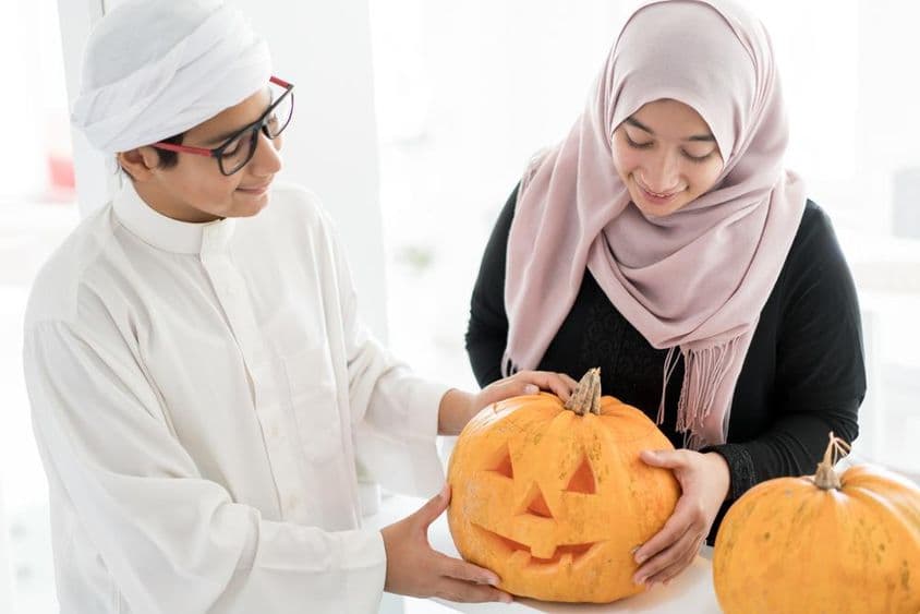 Arabské dieťa s halloweenskou tekvicou.